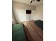 A bedroom featuring wood flooring, two beds, and a closet for storage at 8159 Woodvine Cir, Lakeland, FL 33810