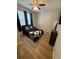 Bedroom with wood-look flooring, ceiling fan, window, and area rug at 8159 Woodvine Cir, Lakeland, FL 33810