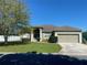 Charming single-story home featuring a well-maintained lawn and inviting front entrance at 8159 Woodvine Cir, Lakeland, FL 33810