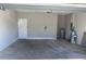 A spacious garage area with a door, electrical outlets, and utility services at 8159 Woodvine Cir, Lakeland, FL 33810
