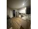 Open-concept kitchen with stainless steel appliances, granite countertops, and wood flooring at 8159 Woodvine Cir, Lakeland, FL 33810