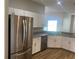 Modern kitchen featuring stainless steel appliances, granite countertops, and bright cabinets at 8159 Woodvine Cir, Lakeland, FL 33810