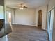 Bright living room featuring wood-look tile flooring and arched doorways at 8159 Woodvine Cir, Lakeland, FL 33810