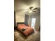 Main bedroom featuring wood-look floors, ceiling fan, and access to main bathroom at 8159 Woodvine Cir, Lakeland, FL 33810
