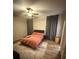 Main bedroom featuring wood-look floors, ceiling fan, and contemporary furnishings at 8159 Woodvine Cir, Lakeland, FL 33810