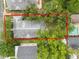 Aerial view showing the home's roof and outline, situated among mature trees at 817 College Ave, Lakeland, FL 33801