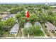 Aerial view showcasing the home nestled among mature trees in a residential neighborhood at 817 College Ave, Lakeland, FL 33801