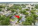 Overhead view of the property in a mature, residential neighborhood with a lake in the distance at 817 College Ave, Lakeland, FL 33801
