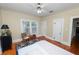 Bright bedroom with hardwood floors and natural light from windows, showcasing a cozy and inviting space at 817 College Ave, Lakeland, FL 33801