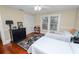 Well-lit bedroom with twin beds, featuring hardwood floors and neutral wall paint at 817 College Ave, Lakeland, FL 33801