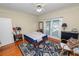 Comfortable bedroom with hardwood floors, a ceiling fan, and natural light from the double doors at 817 College Ave, Lakeland, FL 33801