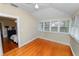Sunlit bedroom with hardwood floors and access to an adjacent space, offering comfort and style at 817 College Ave, Lakeland, FL 33801