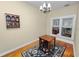 Quaint dining room with hardwood floors, a small table, and a decorative floral area rug at 817 College Ave, Lakeland, FL 33801