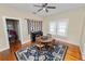 Cozy dining room with hardwood floors, a ceiling fan, and a large rug underneath a round wooden table at 817 College Ave, Lakeland, FL 33801