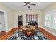 Bright dining room featuring a round wooden table, patterned rug, and a charming decorative wall hanging at 817 College Ave, Lakeland, FL 33801