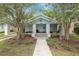 Inviting bungalow with mature trees and landscaped front yard at 817 College Ave, Lakeland, FL 33801