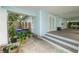 Inviting front porch with swing, light-blue siding, white trim, and light brown steps at 817 College Ave, Lakeland, FL 33801