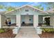 Charming bungalow with a welcoming front porch, swing, and beautiful landscaping at 817 College Ave, Lakeland, FL 33801