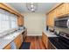 Well-lit galley kitchen with classic wood cabinets, stainless appliances, and a functional layout at 817 College Ave, Lakeland, FL 33801