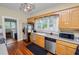 Galley kitchen featuring stainless steel appliances, bright cabinets, and hardwood floors at 817 College Ave, Lakeland, FL 33801
