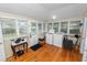Bright laundry room with hardwood floors, white appliances, and abundant natural light from multiple windows at 817 College Ave, Lakeland, FL 33801