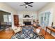 Bright living room with wood floors, ceiling fan, and french doors at 817 College Ave, Lakeland, FL 33801