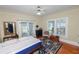 Comfortable main bedroom featuring french doors, a ceiling fan, and hardwood floors at 817 College Ave, Lakeland, FL 33801