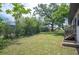 Large, grassy backyard shaded by mature trees, offering a serene outdoor space at 818 Woodward St, Lakeland, FL 33803