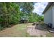 Expansive backyard with play area including a picnic table, swing set, and playhouse surrounded by lush trees at 818 Woodward St, Lakeland, FL 33803