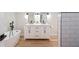 Bathroom featuring a modern vanity with dual sinks, a freestanding tub, and light wood flooring at 818 Woodward St, Lakeland, FL 33803