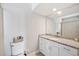 Bathroom featuring vanity with granite top, white cabinets, toilet and shower curtain at 818 Woodward St, Lakeland, FL 33803