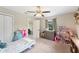 Cozy bedroom with a neutral palette, filled with toys, and a view to the ensuite bath at 818 Woodward St, Lakeland, FL 33803