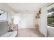 Another bedroom with a crib, a side table, and a window with view of foliage at 818 Woodward St, Lakeland, FL 33803