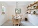 Cozy dining space with tile floors, decorative shelving, and natural lighting, perfect for intimate meals at 818 Woodward St, Lakeland, FL 33803