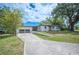 Beautiful single-story home featuring a pristine lawn and an attached two-car garage at 818 Woodward St, Lakeland, FL 33803
