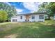 Charming single story home with a manicured lawn and attached two car garage at 818 Woodward St, Lakeland, FL 33803