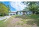 Attractive one-story home boasts a well-kept lawn and a two-car garage at 818 Woodward St, Lakeland, FL 33803