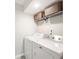 Bright laundry room featuring a white washer and dryer with baskets on a wire shelf above at 818 Woodward St, Lakeland, FL 33803