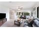 Bright living room featuring neutral paint, carpet and large windows at 818 Woodward St, Lakeland, FL 33803