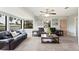 Spacious living room with plush carpet, a ceiling fan, and large windows at 818 Woodward St, Lakeland, FL 33803