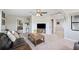 Bright living room with ceiling fan, neutral walls, a mounted television, and contemporary rustic decor at 818 Woodward St, Lakeland, FL 33803