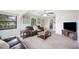 Inviting living room features plush carpet, neutral walls, and a ceiling fan, offering comfortable living space at 818 Woodward St, Lakeland, FL 33803