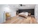 Another view of main bedroom with black accent wall, bed, office space and wicker chair at 818 Woodward St, Lakeland, FL 33803