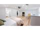 Open main bedroom with en suite bathroom, closet, television, and wicker chair at 818 Woodward St, Lakeland, FL 33803