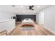 Main bedroom with bed, dark accent wall, adjacent office space, and light wood floors at 818 Woodward St, Lakeland, FL 33803