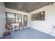 Cozy, covered patio featuring neutral paint, black trim and modern furnishings at 818 Woodward St, Lakeland, FL 33803