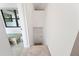 View up stairway with small door leading to storage underneath and a view of playroom at 818 Woodward St, Lakeland, FL 33803