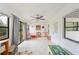 Spacious sunroom with white walls, tile floors, ceiling fan and sliding glass doors to the outside at 818 Woodward St, Lakeland, FL 33803