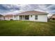 View of the house from the backyard featuring a covered porch and sliding glass doors at 8323 Greystone Dr, Lakeland, FL 33810