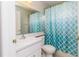 Bathroom featuring a sink with a mirror and a shower/tub with a blue curtain at 8323 Greystone Dr, Lakeland, FL 33810